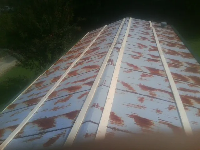 Rusted metal roof panels with new wood purlins before replacement — Storm Damage Roof Repair in Pine Bush by Roofing Brothers