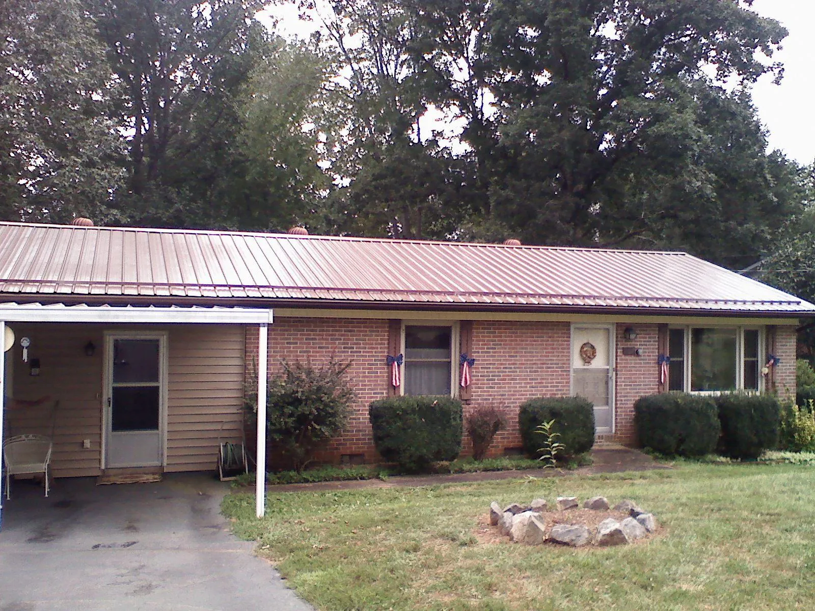 Bronze metal roof and carport on a brick ranch home — Roof Repair work by our crew in Pine Bush