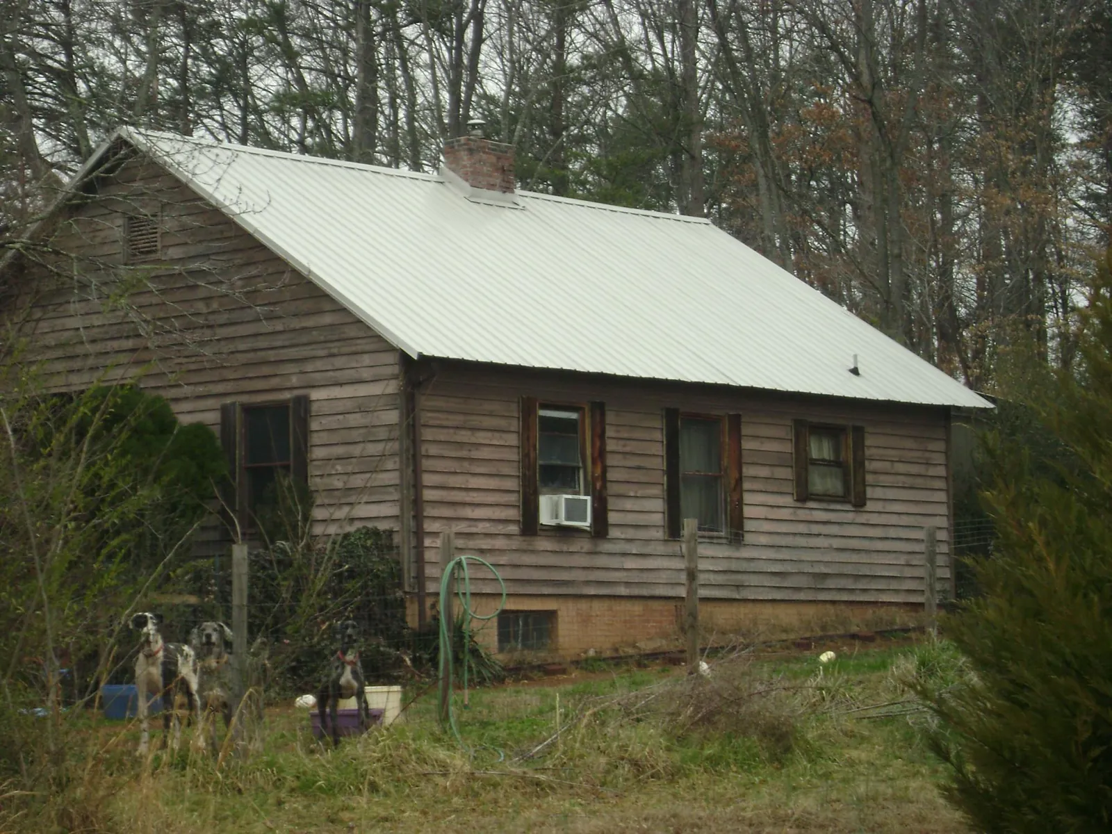 White metal roof on an old wood sided farmhouse, from a Metal Roof Installation job in Pine Bush